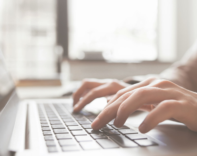 complaints Hands typing on laptop